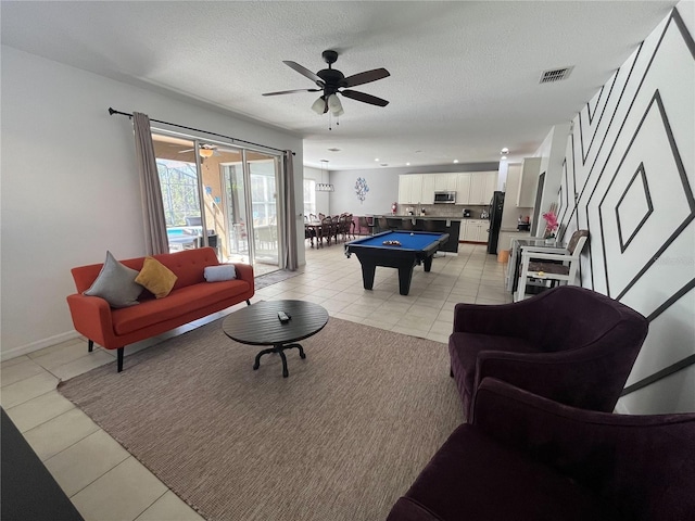 rec room with pool table, visible vents, a textured ceiling, and light tile patterned floors