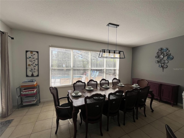 dining area featuring a healthy amount of sunlight, a textured ceiling, and light tile patterned floors