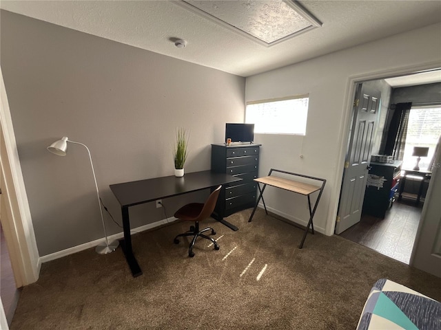 home office featuring carpet floors, a textured ceiling, and baseboards