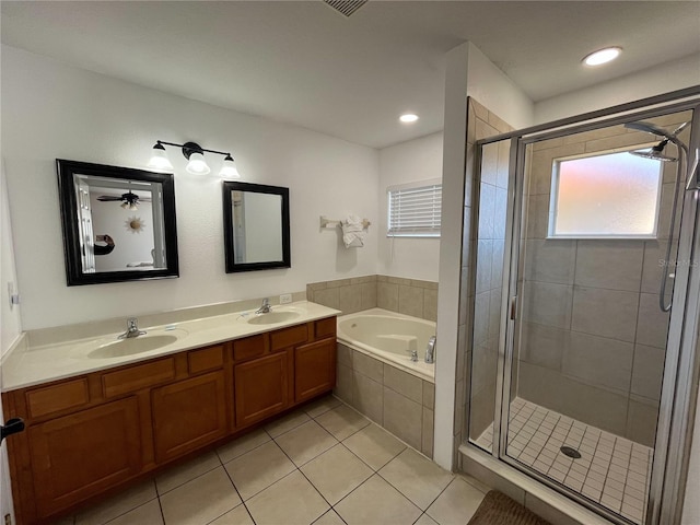 full bathroom with a garden tub, a shower stall, a sink, and tile patterned floors