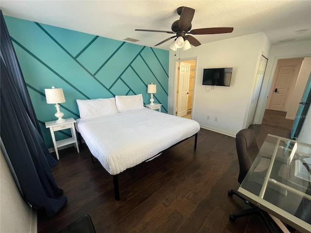 bedroom with baseboards, visible vents, a ceiling fan, wood finished floors, and a textured ceiling