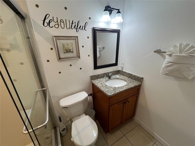 bathroom with toilet, a stall shower, vanity, and tile patterned floors