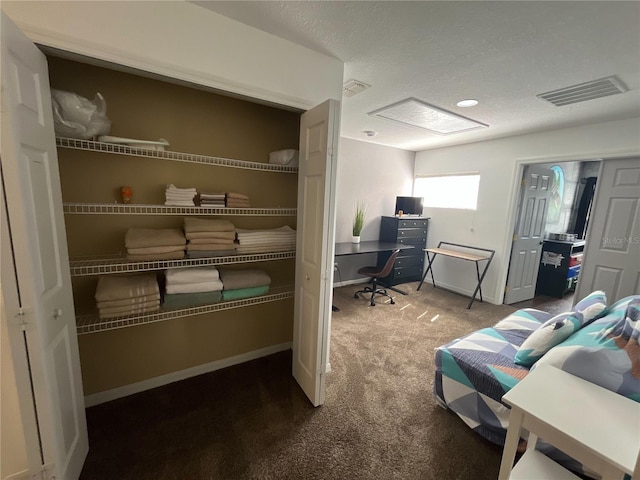 office space with carpet, visible vents, a textured ceiling, and baseboards