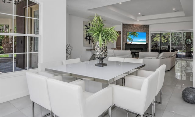 dining space featuring a raised ceiling