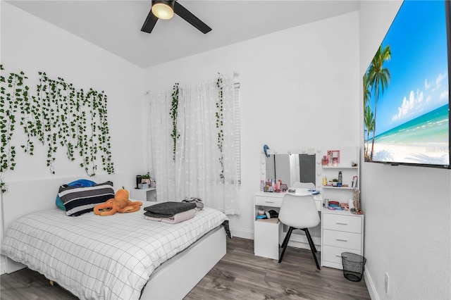 bedroom with dark wood-type flooring and ceiling fan