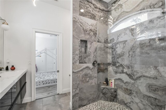 bathroom featuring vanity and tiled shower