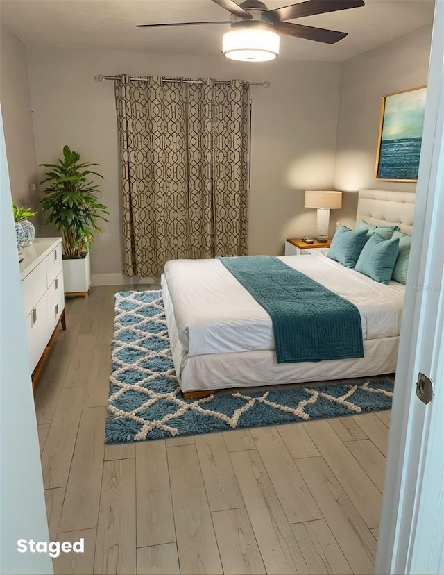 bedroom with ceiling fan and wood finished floors