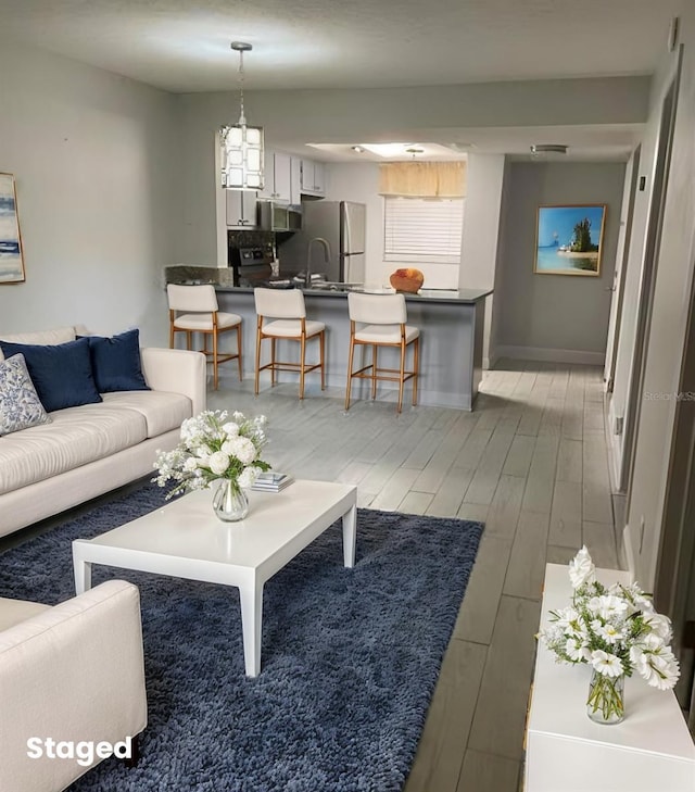 1804 University Ln Unit 308, Cocoa, FL 32922 - living area featuring light wood-style flooring and baseboards