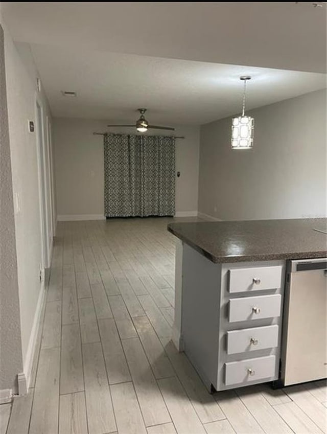 1804 University Ln Unit 308, Cocoa, FL 32922 - kitchen with dark countertops, light wood-style floors, open floor plan, and pendant lighting