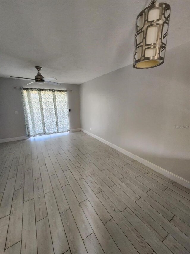 1804 University Ln Unit 308, Cocoa, FL 32922 - unfurnished room featuring ceiling fan, wood finished floors, and baseboards