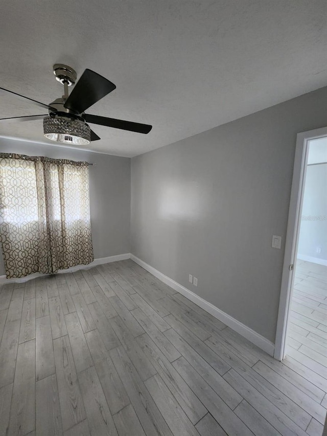 1804 University Ln Unit 308, Cocoa, FL 32922 - spare room featuring a ceiling fan, wood finished floors, and baseboards