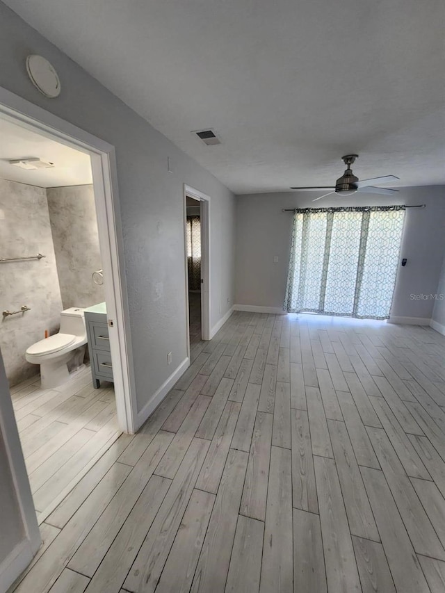 1804 University Ln Unit 308, Cocoa, FL 32922 - empty room featuring ceiling fan, light wood-style flooring, and baseboards