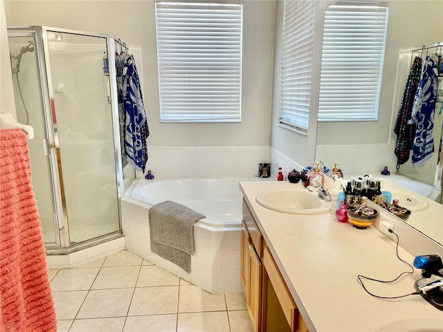 bathroom featuring tile patterned flooring, plus walk in shower, and vanity