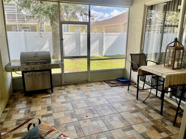 sunroom / solarium featuring a healthy amount of sunlight