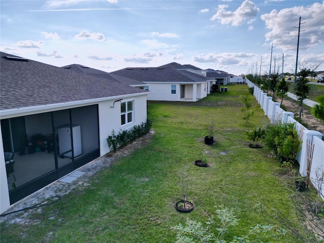 view of yard with a sunroom