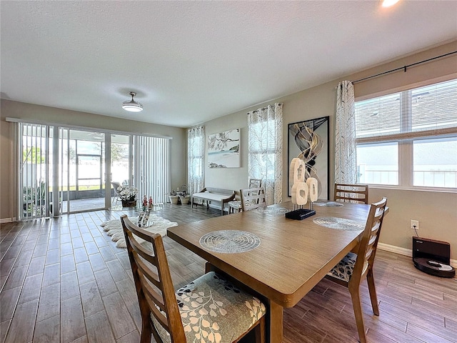 dining area with hardwood / wood-style flooring and a textured ceiling