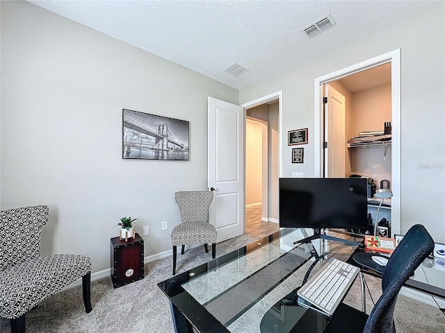 office space with carpet flooring and a textured ceiling