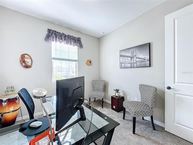 carpeted home office with a textured ceiling