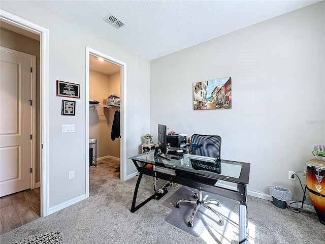 home office featuring a textured ceiling