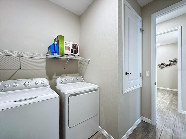 laundry area featuring hardwood / wood-style flooring and independent washer and dryer