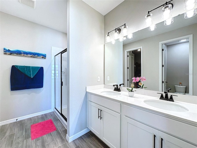 bathroom featuring vanity, toilet, and walk in shower