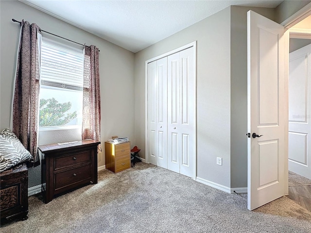 bedroom featuring light colored carpet, a closet, and a textured ceiling