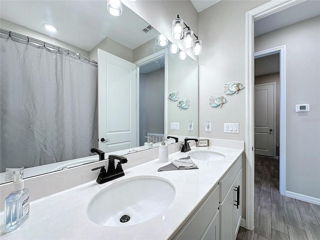 bathroom with hardwood / wood-style flooring and vanity