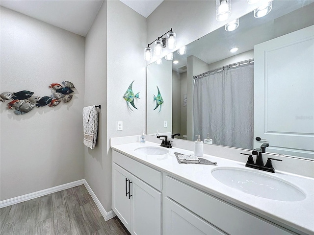 bathroom with walk in shower, wood-type flooring, and vanity