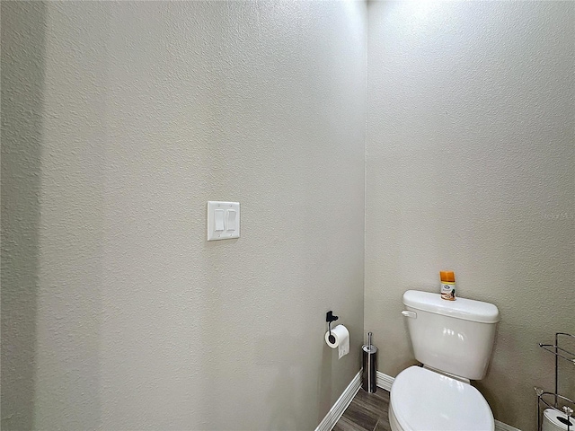 bathroom featuring hardwood / wood-style flooring and toilet