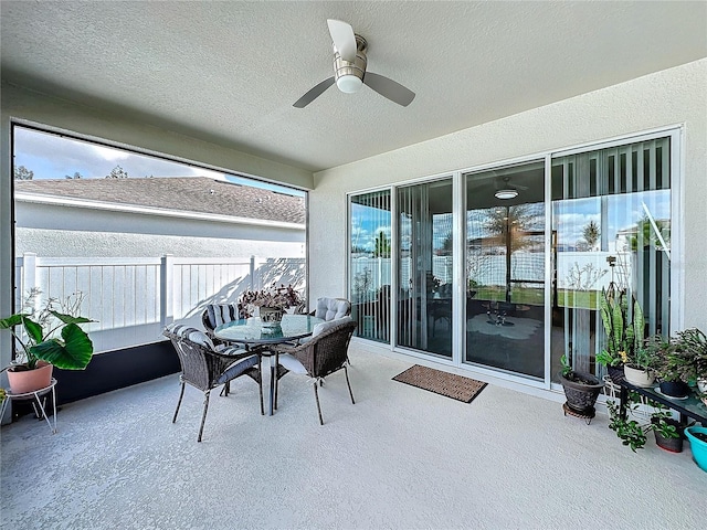 sunroom / solarium featuring ceiling fan