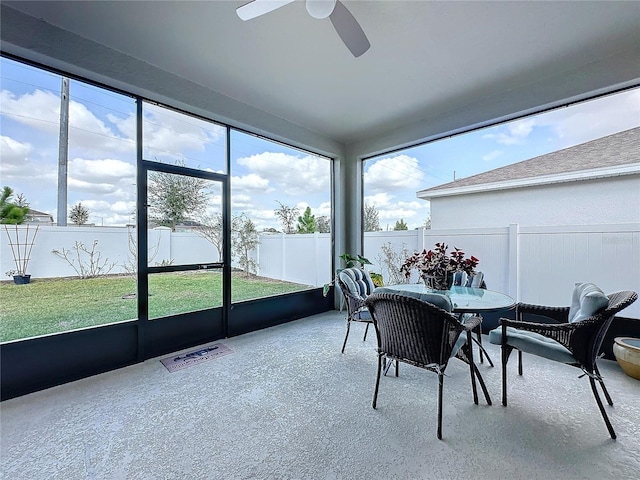 sunroom / solarium featuring ceiling fan