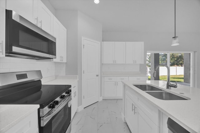 kitchen with sink, stainless steel appliances, hanging light fixtures, and white cabinets