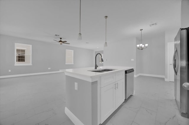 kitchen featuring sink, white cabinetry, appliances with stainless steel finishes, an island with sink, and pendant lighting