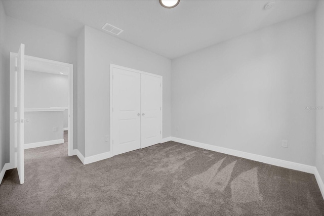 unfurnished bedroom with carpet and a closet