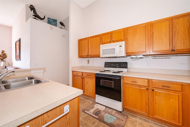 kitchen featuring sink, electric range oven, and light tile patterned floors