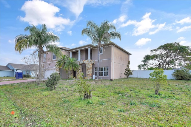 view of front of property featuring a garage and a front yard