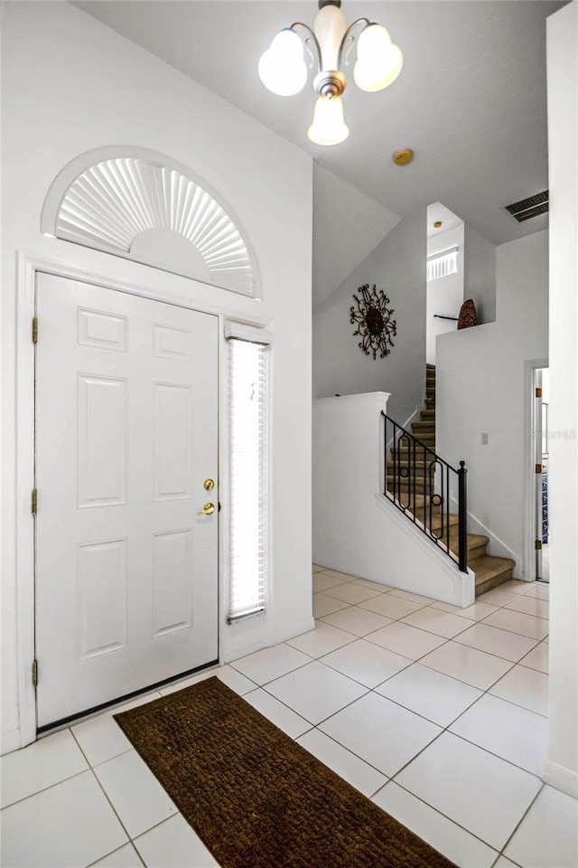 foyer featuring a notable chandelier and light tile patterned flooring