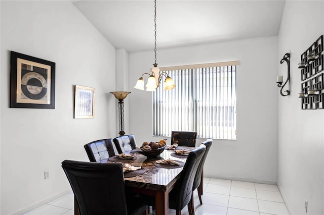 tiled dining space with a chandelier