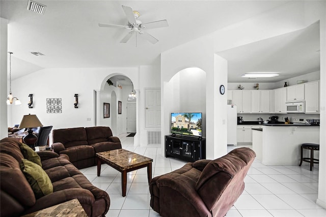 tiled living room featuring lofted ceiling and ceiling fan