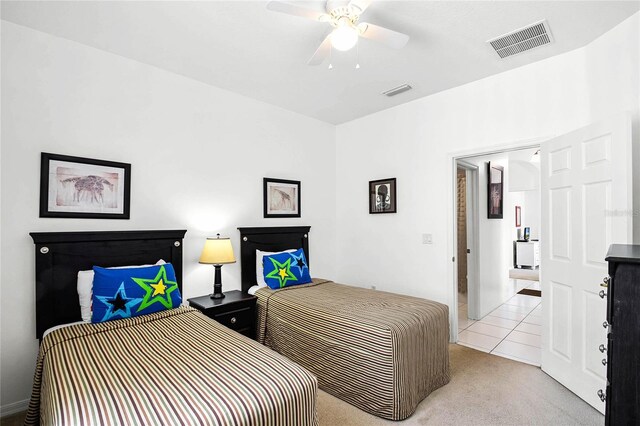 tiled bedroom featuring ceiling fan