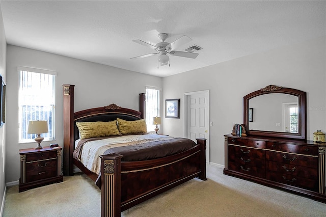 bedroom featuring ceiling fan and light carpet