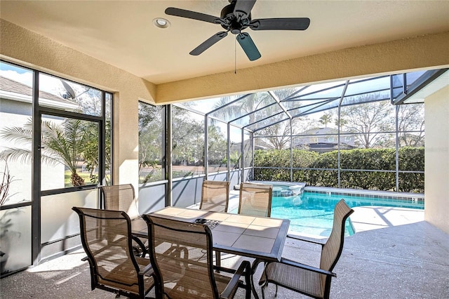 view of swimming pool featuring an in ground hot tub, glass enclosure, and a patio area