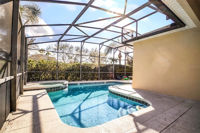 view of swimming pool with a patio, an in ground hot tub, and glass enclosure