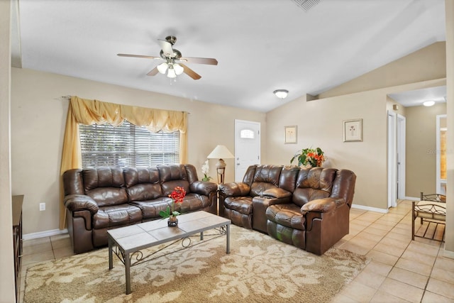 tiled living room with ceiling fan and vaulted ceiling