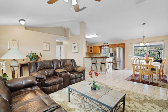 living room with vaulted ceiling, light tile patterned floors, and ceiling fan