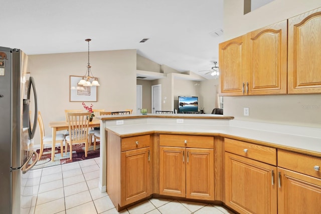 kitchen with light tile patterned floors, kitchen peninsula, and stainless steel refrigerator with ice dispenser