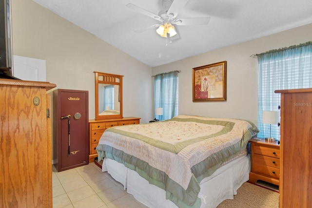 bedroom with ceiling fan, lofted ceiling, multiple windows, and light tile patterned floors