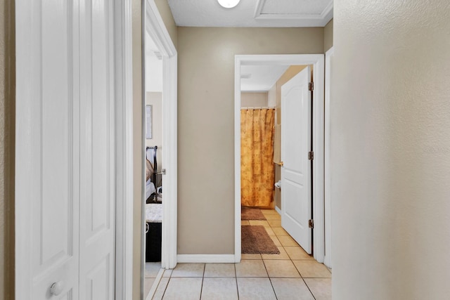 hall with light tile patterned floors