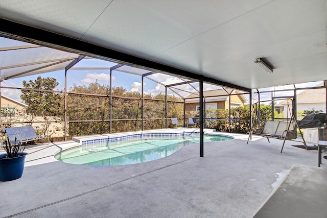 view of swimming pool with a lanai and a patio area