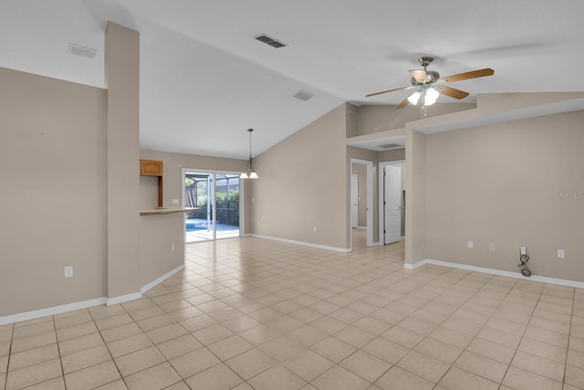 spare room with lofted ceiling, ceiling fan, visible vents, and baseboards